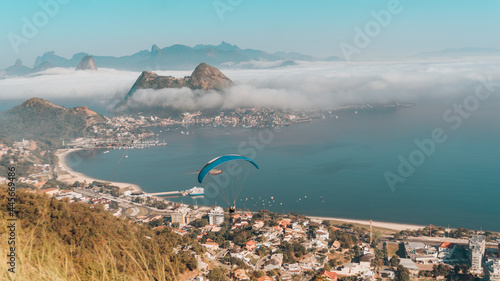 Scenic view of a paraglider soaring above the Niteroe City Park in Charitas, Brazil photo