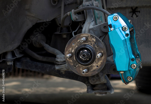 Brake caliper and old bearing of car check maintenance and change brake pad car service concept in shop