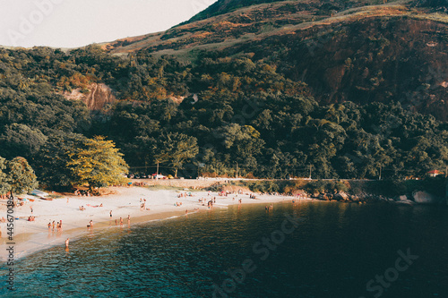 A scenic view of tourists on the beautiful shoreline at summertime