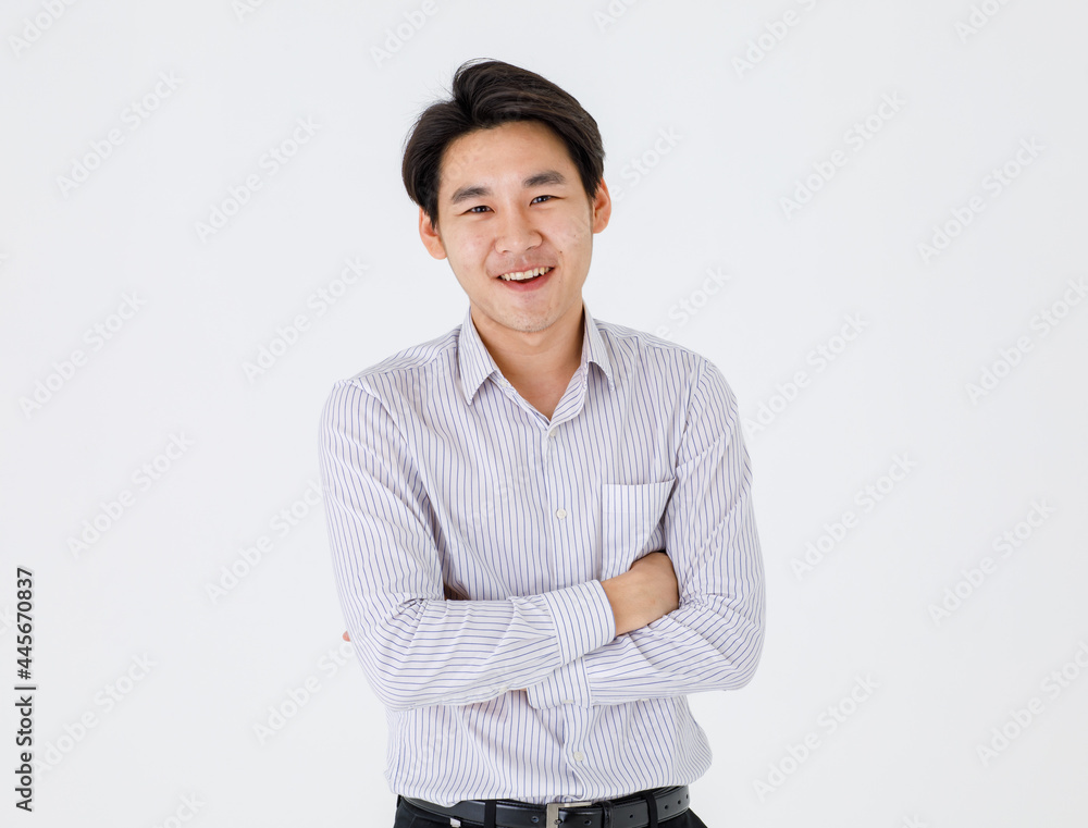 Portrait isolated Close up studio mug shot of young happy handsome Asian professional successful businessman wears stripe long sleeve shirt stand crossed arms smiling in front of white background Portrait isolated Close up studio mug shot of young happy handsome Asian professional successful businessman wears stripe long sleeve shirt stand crossed arms smiling in front of white background