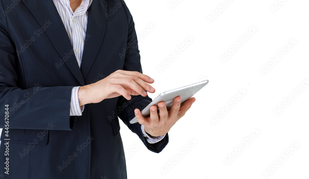 Isolated studio close up shot of silver wireless digital tablet in hand of successful businessman wears formal suit with long sleeve stripe shirt stand touching monitor in front of white background Isolated studio close up shot of silver wireless digital tablet in hand of successful businessman wears formal suit with long sleeve stripe shirt stand touching monitor in front of white background
