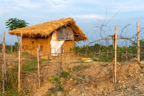 A beautiful little mud house surrounded by green trees under the blue sky at Indian Village. dreamy scenario.