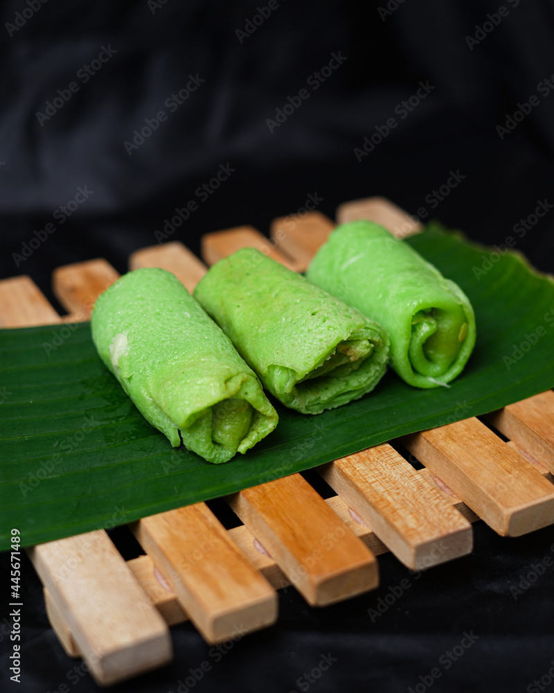 Pandan green pancake rolls on black background. Dadar Gulung is a