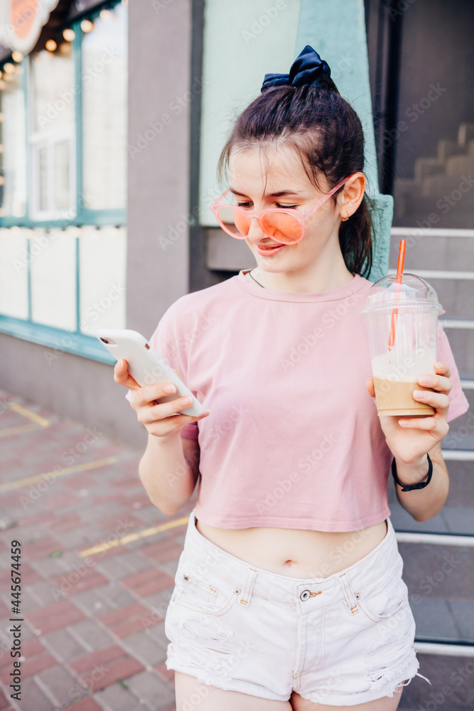 Playful cool funky hipster young girl with mobile phone app while walking on city street – Street fashion and new normal concept of youth generation Playful cool funky hipster young girl with mobile phone app while walking on city street – Street fashion and new normal concept of youth generation