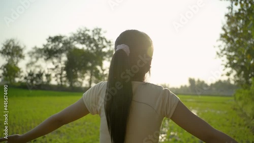 portrait of a beautiful young girl looking for exotic scenery to enjoy and relax on sunset photo