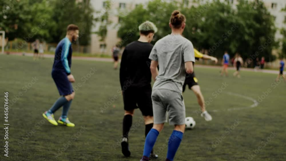 The players of the soccer club train at the city stadium and spend the game moments by dividing into teams. Slow motion The players of the soccer club train at the city stadium and spend the game moments by dividing into teams. Slow motion
