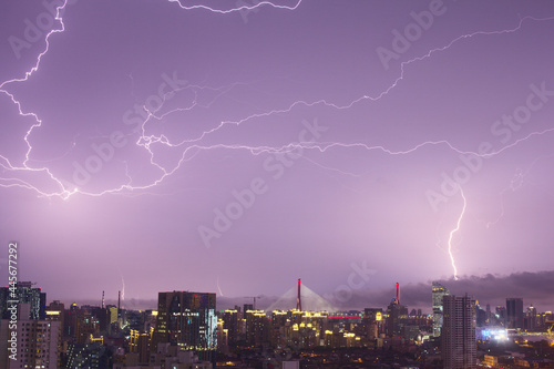 Lightning in purple sky at night in a Chinese city, abnormal natural Phenomenon