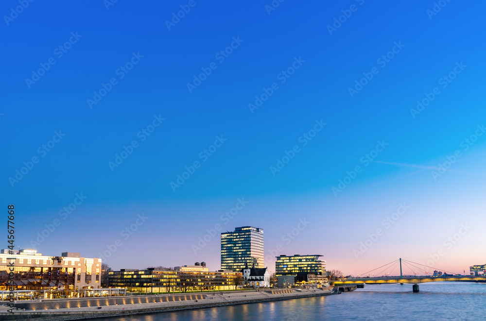 Nice night view, Rhine in Cologne, Germany, skyscrapers and bridge across Rhine