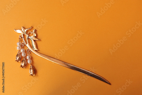 Chinese hairpin hair clips on a illuminated golgen yellow background. Chinese traditional jewelry. photo