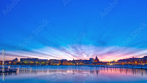 Night view of the seaside city of Helsinki in Finland and the sky reflected in the water