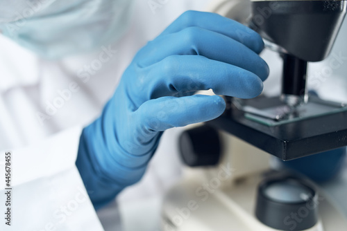 Woman in white coat microscope research diagnostics professionals