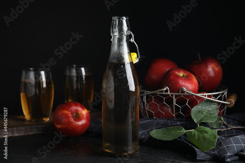 Composition with delicious apple cider on black table