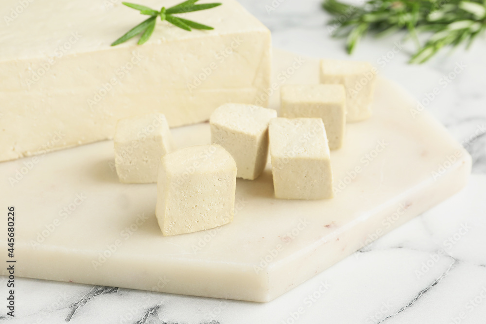 Delicious tofu with rosemary on white marble table, closeup Delicious tofu with rosemary on white marble table, closeup