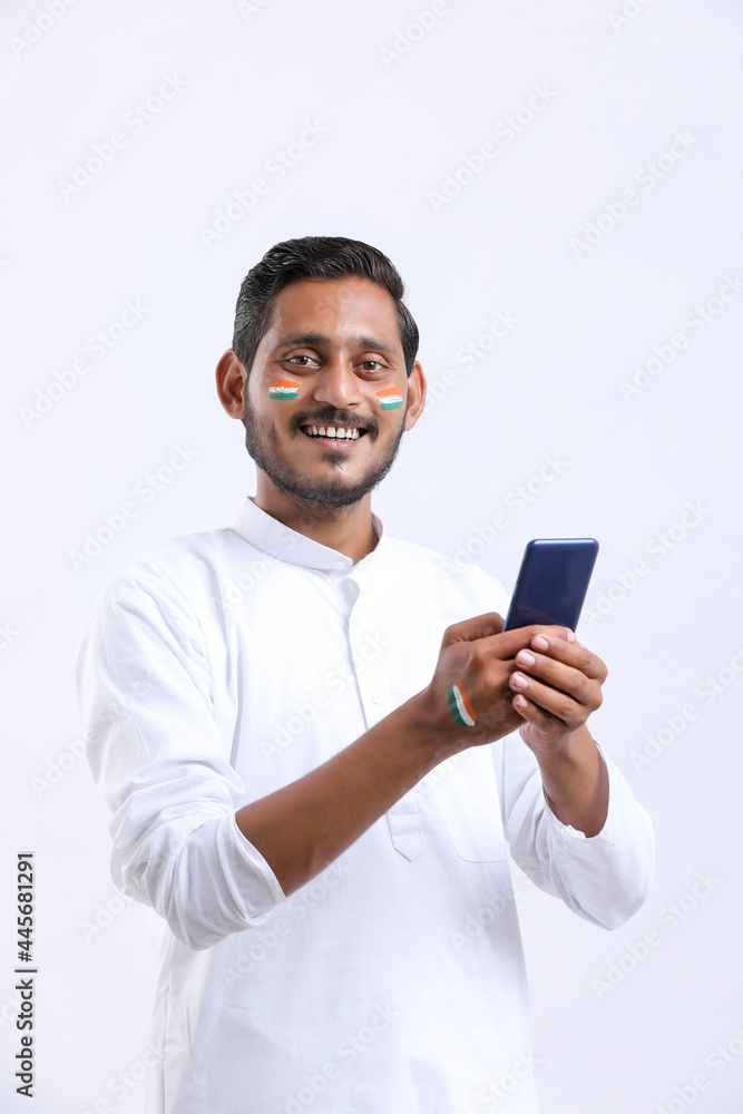 young indian man celebrating independence day or republic day and using smartphone. young indian man celebrating independence day or republic day and using smartphone.