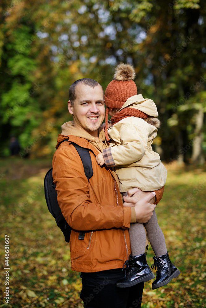 family, parenthood, love and care concept - father and cute little daughter in autumn park family, parenthood, love and care concept - father and cute little daughter in autumn park