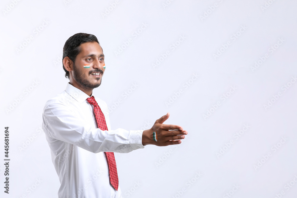 Young Indian man handshaking after good deal. Young Indian man handshaking after good deal.