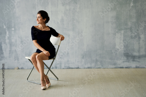 Wallpaper Mural woman sitting on a chair in a black dress posing fashion luxury Torontodigital.ca