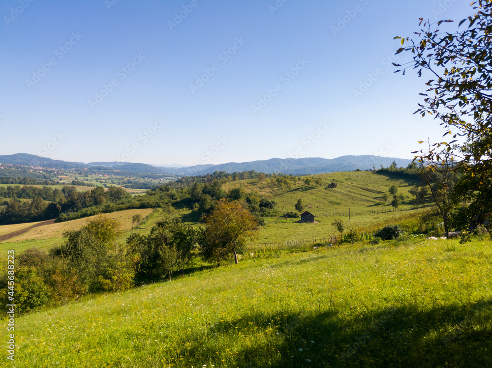 Scenic view of hilly countryside in village of Gornji Osječani near Doboj during clear sunny summer day. Scenic view of hilly countryside in village of Gornji Osječani near Doboj during clear sunny summer day.