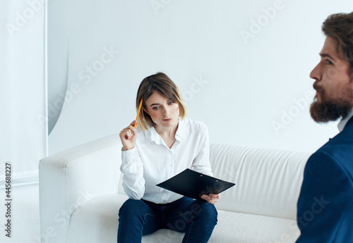 man and woman sitting on the couch communication work discussion