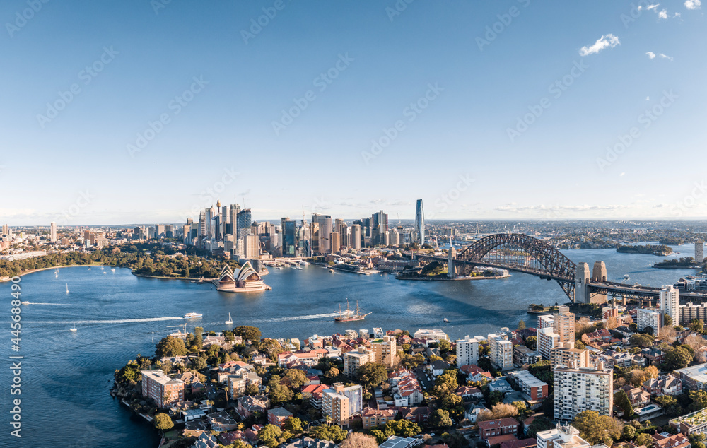 Fototapeta premium Stunning wide angle panoramic aerial drone view of the City of Sydney, Australia skyline with Harbour Bridge and Kirribilli suburb in foreground. Photo shot in May 2021, showing newest skyscrapers.