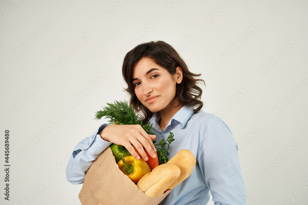 brunette with a package of groceries healthy food vegetables supermarket brunette with a package of groceries healthy food vegetables supermarket