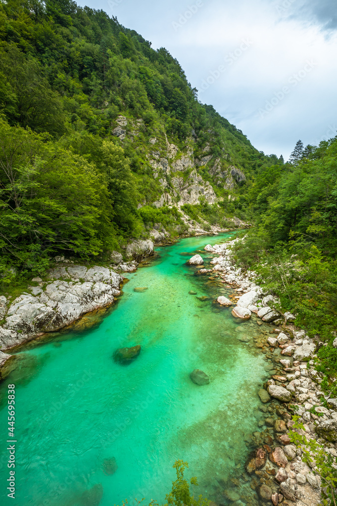 Fototapeta premium Soca Valley, Slovenia - River Soca is a beautiful turquoise water river in the Slovenian Alps located near the town of Kobarid in Triglav National Park, Julian Alps, Europe