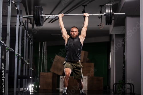 Muscular athlete lifting very heavy barbell © Nikola Spasenoski