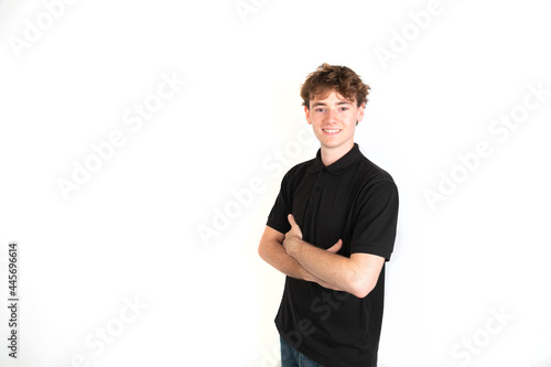 Happy guy smiling looking at camera, arms crossed. portrait, white background, 18-20 years old. White european guy.