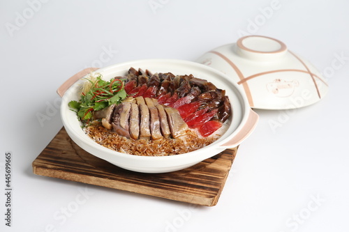 cook assorted chinese waxed meat with rice and dark soy sauce in hot clay pot asian menu