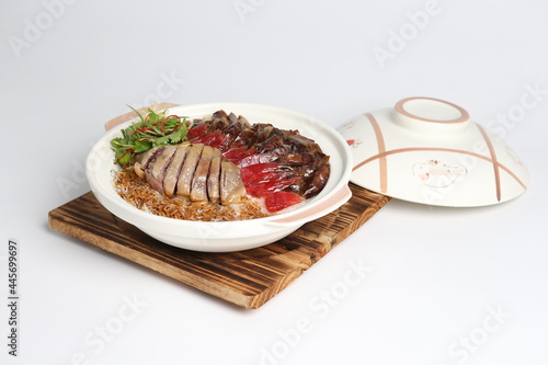 cook assorted chinese waxed meat with rice and dark soy sauce in hot clay pot asian menu