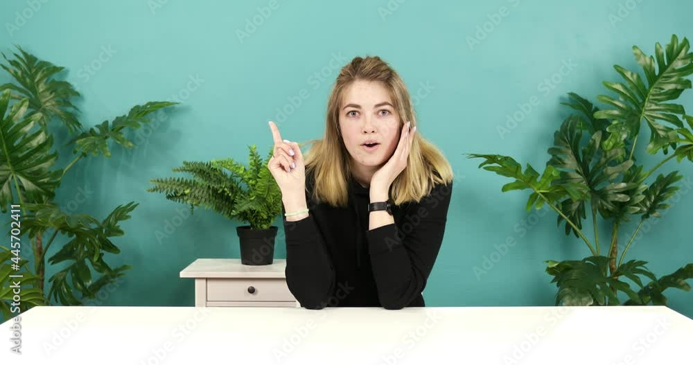 Smiling happy woman showing eureka gesture. Portrait of young thinking pondering girl having idea moment pointing finger up. Smiling happy woman showing eureka gesture. Portrait of young thinking pondering girl having idea moment pointing finger up.