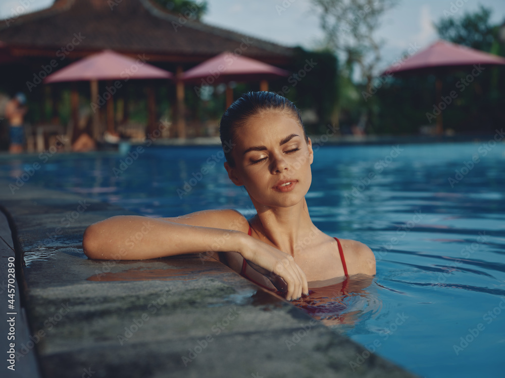 woman in a swimsuit Swimming in the pool vacation hotel tropics