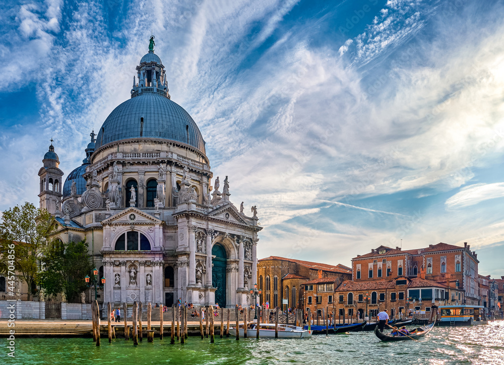 Beautiful view of iconic basilica di Santa Maria della Salute or St Mary of Health by waterfront of Grand Canal, Venice, Italy. Famous landmark.