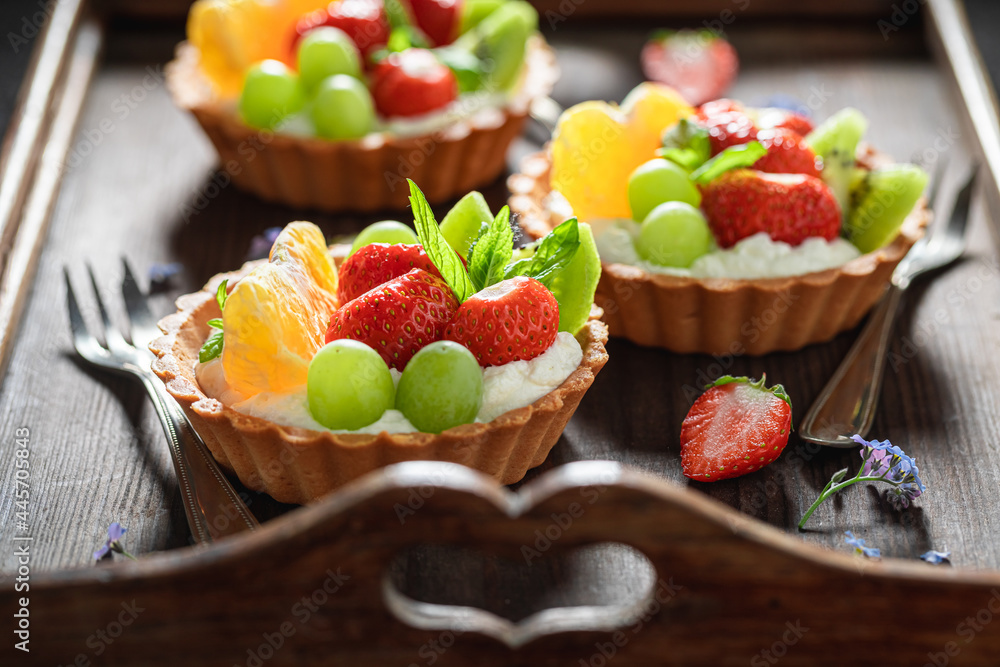 Delicious mini tart with strawberries and grapes. Simple fruit dessert. Delicious mini tart with strawberries and grapes. Simple fruit dessert.