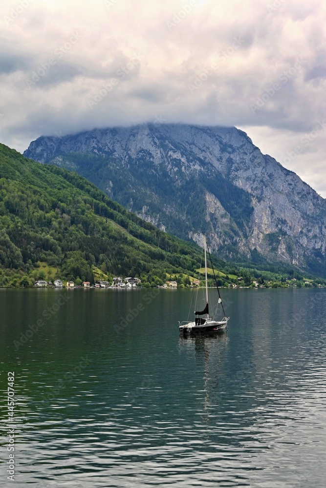 Beautiful misty and cloudy landscape with lake and mountains in summer. Natural colorful background. Traunsee lake in the Austrian applause - Gmunden.