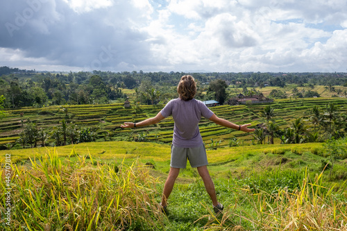 Young man admiring beautiful view of the rice terrace rear view