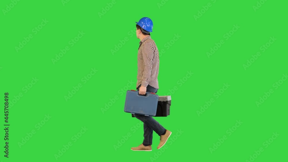 A manual worker with a toolbox walking on a Green Screen, Chroma Key. A manual worker with a toolbox walking on a Green Screen, Chroma Key.