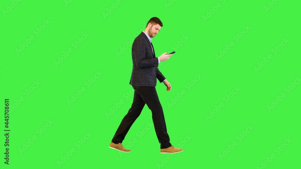Successful businessman walk using smartphone read email message, chat with partners in mobile app on a Green Screen, Chroma Key. Successful businessman walk using smartphone read email message, chat with partners in mobile app on a Green Screen, Chroma Key.
