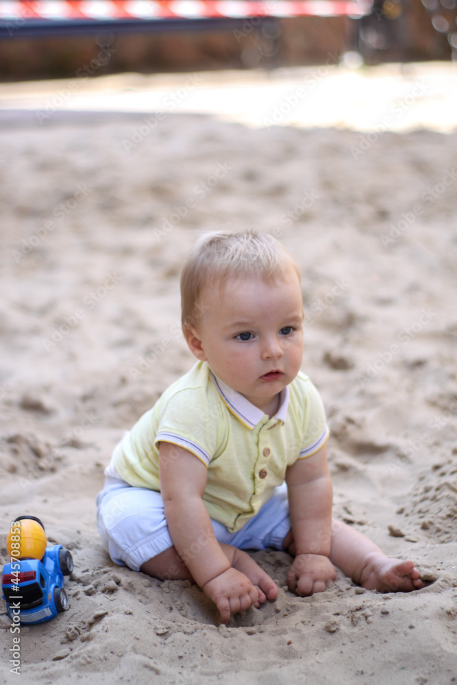 little boy playing in the sand. baby plays with sand. Summer rest. Sun, sea, beach, sand. Rest, childhood. little boy playing in the sand. baby plays with sand. Summer rest. Sun, sea, beach, sand. Rest, childhood.