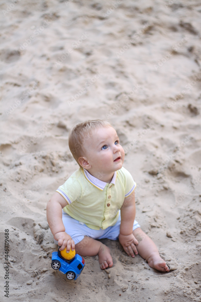 little boy playing in the sand. baby plays with sand. Summer rest. Sun, sea, beach, sand. Rest, childhood. little boy playing in the sand. baby plays with sand. Summer rest. Sun, sea, beach, sand. Rest, childhood.