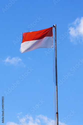 National Flag of Republic Indonesia in Portrait With little cloud