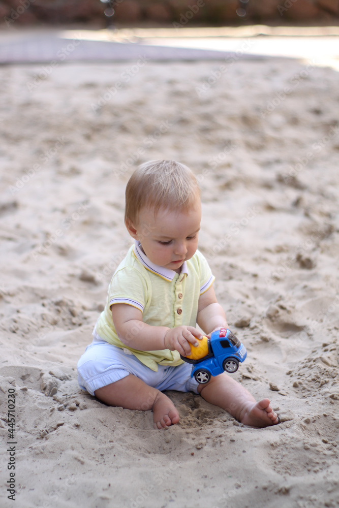little boy playing in the sand. baby plays with sand. Summer rest. Sun, sea, beach, sand. Rest, childhood. little boy playing in the sand. baby plays with sand. Summer rest. Sun, sea, beach, sand. Rest, childhood.