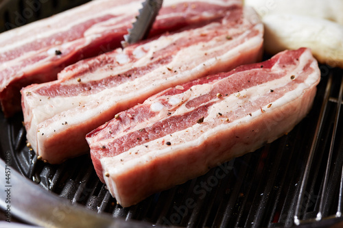 Raw pork belly on the grill