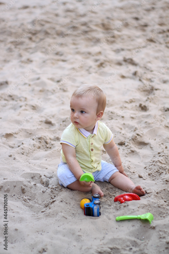 little boy playing in the sand. baby plays with sand. Summer rest. Sun, sea, beach, sand. Rest, childhood. little boy playing in the sand. baby plays with sand. Summer rest. Sun, sea, beach, sand. Rest, childhood.