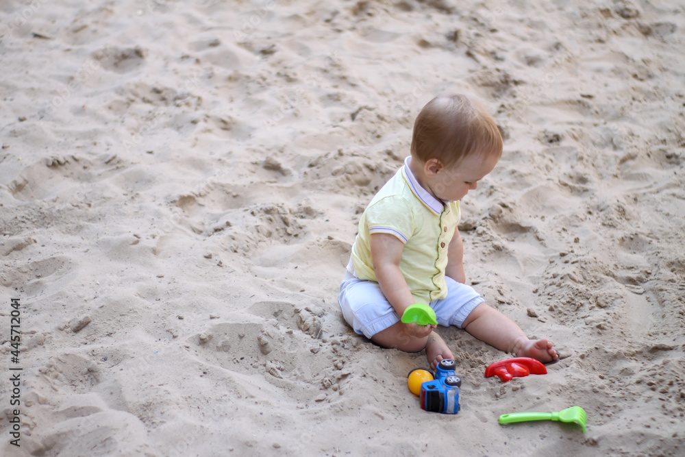little boy playing in the sand. baby plays with sand. Summer rest. Sun, sea, beach, sand. Rest, childhood. little boy playing in the sand. baby plays with sand. Summer rest. Sun, sea, beach, sand. Rest, childhood.