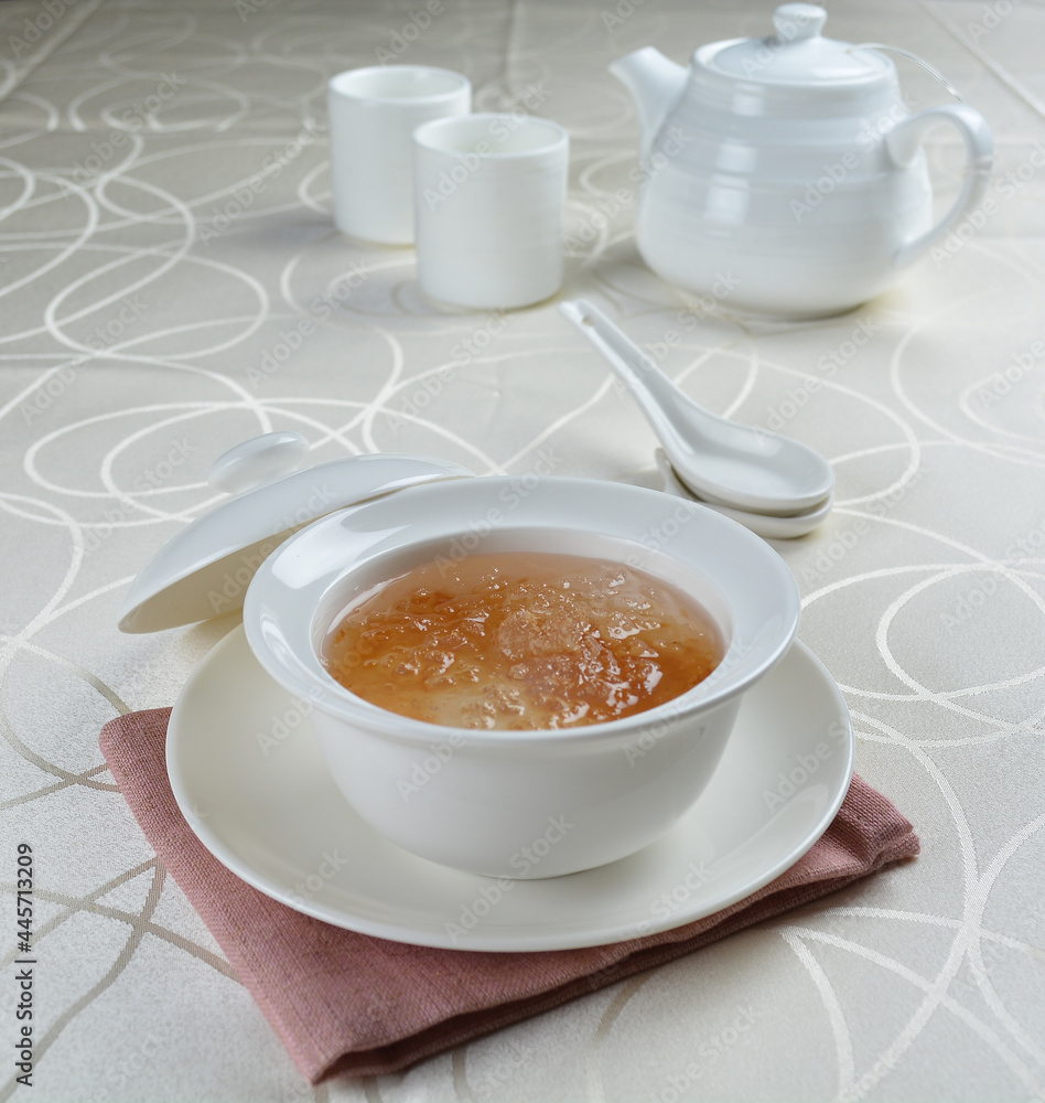 luxury chilled sweet fresh bird nest soup with almond paste and peach resin in bowl and pink table cloth halal healthy dessert menu luxury chilled sweet fresh bird nest soup with almond paste and peach resin in bowl and pink table cloth halal healthy dessert menu
