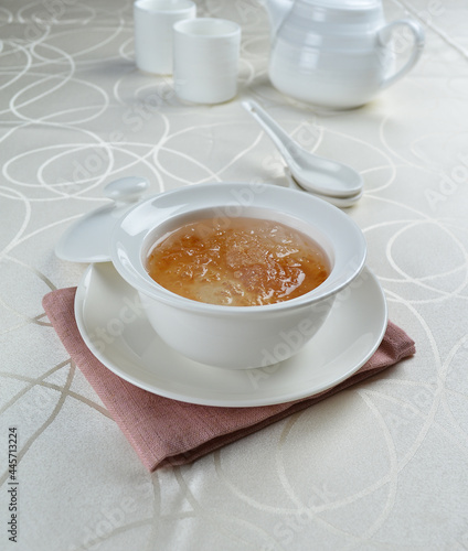 luxury chilled sweet fresh bird nest soup with almond paste and peach resin in bowl and pink table cloth halal healthy dessert menu