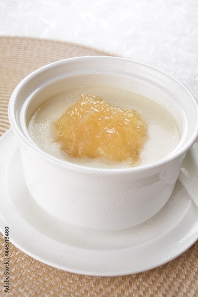 luxury chilled sweet fresh bird nest soup with almond paste and peach resin in bowl and pink table cloth halal healthy dessert menu luxury chilled sweet fresh bird nest soup with almond paste and peach resin in bowl and pink table cloth halal healthy dessert menu