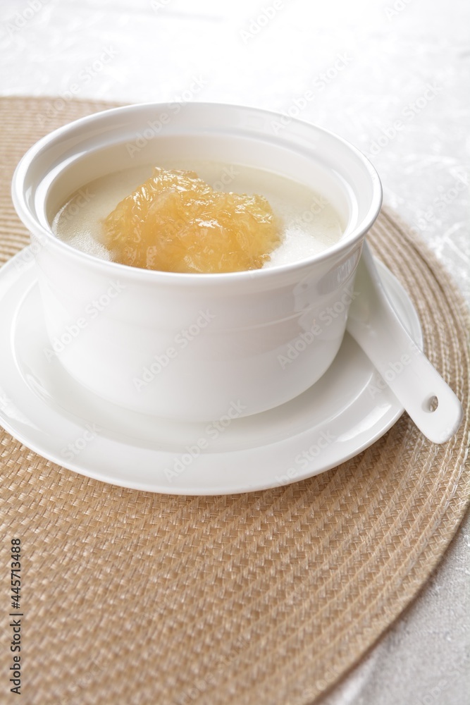 luxury chilled sweet fresh bird nest soup with almond paste and peach resin in bowl and pink table cloth halal healthy dessert menu luxury chilled sweet fresh bird nest soup with almond paste and peach resin in bowl and pink table cloth halal healthy dessert menu