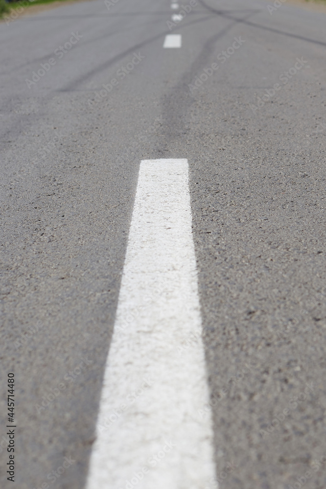 Fototapeta premium marking on the road going into the distance, asphalt road